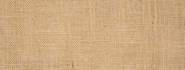 Cotton woven fabric background with flecks of varying colors of beige and brown. with copy space. office desk concept / Hessian sackcloth burlap woven texture background