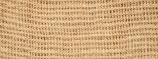 Cotton woven fabric background with flecks of varying colors of beige and brown. with copy space. office desk concept, Hessian sackcloth burlap woven texture background High Resolution ,panoramic 
