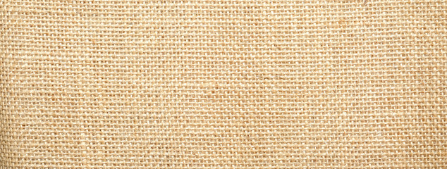 Fototapeta premium Cotton woven fabric background with flecks of varying colors of beige and brown. with copy space. office desk concept / Hessian sackcloth burlap woven texture background