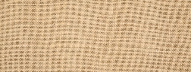 Cotton woven fabric background with flecks of varying colors of beige and brown. with copy space....