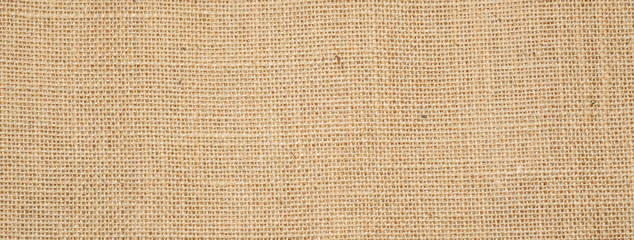 Cotton woven fabric background with flecks of varying colors of beige and brown. with copy space. office desk concept / Hessian sackcloth burlap woven texture background