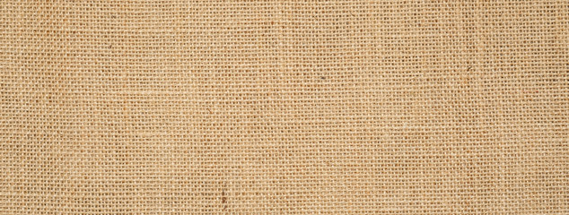 Cotton woven fabric background with flecks of varying colors of beige and brown. with copy space. office desk concept / Hessian sackcloth burlap woven texture background