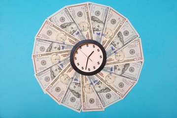 Concept of clock and dollar. Clock on kaleidoscope from money.