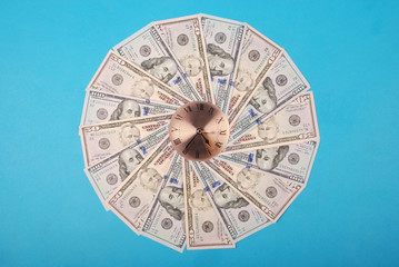 Concept of clock and dollar. Clock on kaleidoscope from money.