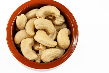 Cashews in a bowl on a white background