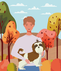 young man with cute dog mascot in the autumn camp