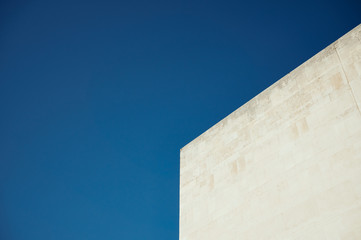 Part of building against blue sky
