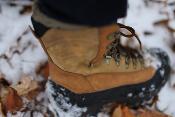 man wearing boots on the snow