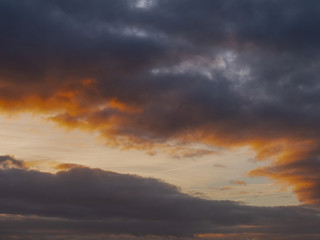 Dark blue and orange color clouds at sunset of sunrise.