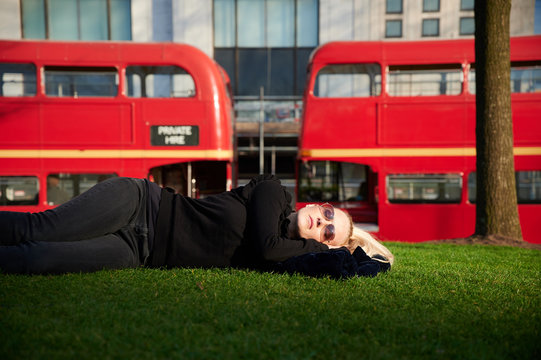 Woman lying down on meadow of London