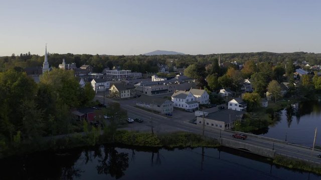 Aerial drone shot of small New Hampshire town with mountain in distance