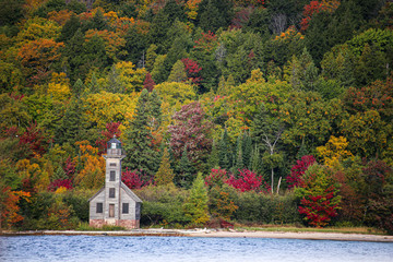 small church surrounded with forest in autumn