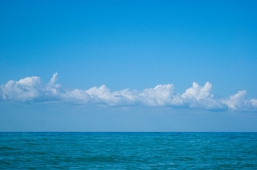 Obraz premium White clouds over the blue calm sea - nature, beach, landscape