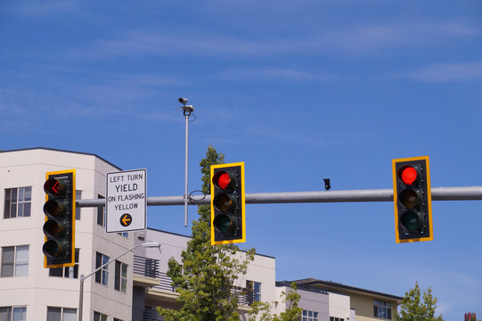 Traffic lights at the intersection of streets in the city. Mounted traffic monitoring system.