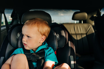 Boy looking out of window in carseat