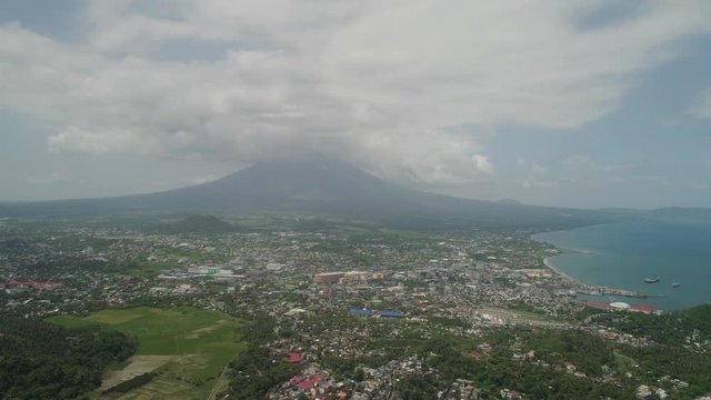 Aerial view city Legazpi in background Mayon volcano. Tropical landscape city near volcano on seashore, Philippines, Luzon.