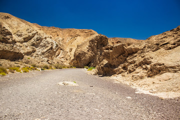 desert canyon Middle East warm waste land scenery landscape with rocky sand stone hills environment