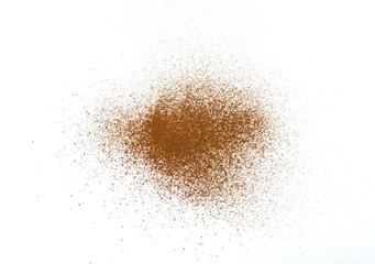 Spice cinnamon powder isolated on a white background. Cinnamon powder spilled on a white surface.