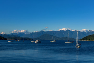 Clouds, mountains, water and boats near Gibsons, BC