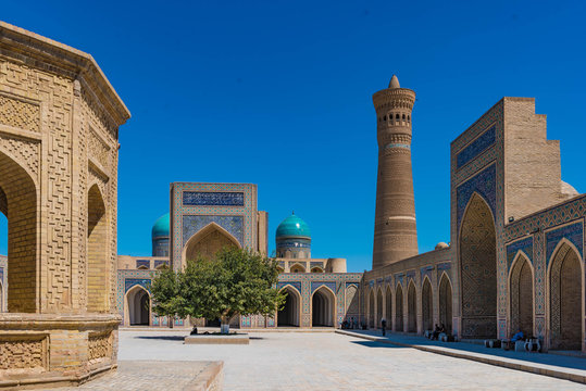 Inner Courtyard of the Kalyan mosque with minaret and iwan of the mir-i-arab madrasa in Bukhara Uzbekistan