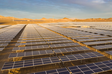 Aerial view of hundreds solar energy  panels rows along the dry lands at Atacama Desert, Chile....