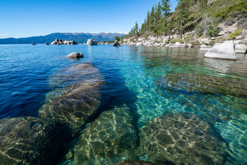 USA, Nevada, Washoe County, Lake Tahoe. Granite boulders under the clear blue to emerald waters...
