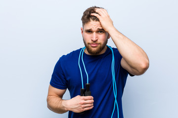 Young caucasian sportsman with a jump rope being shocked, she has remembered important meeting.