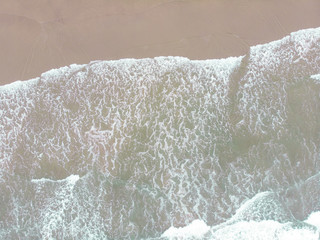 Abstract texture of water with waves and sand. Top view of turquoise water as background, Ocean, sea, lake.