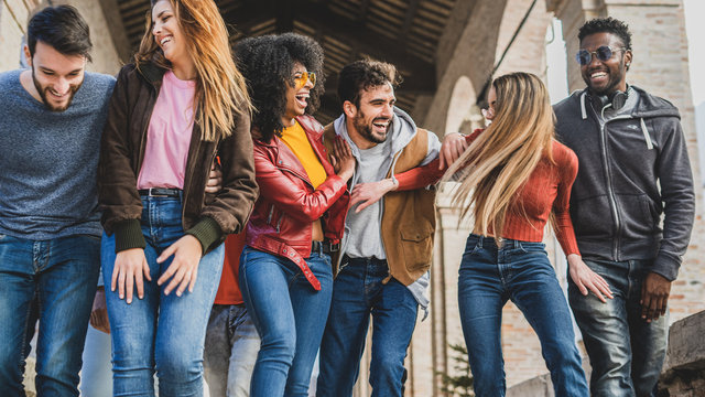 Multiracial Group Of Millennials Having Fun Walking In The City In The Morning.