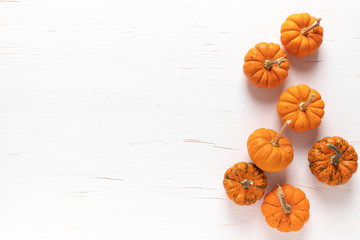 Small decorative pumpkins on white wooden background. Autumn, fall, thanksgiving or halloween day...