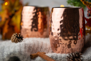 Two cups of hot drink on christmas background