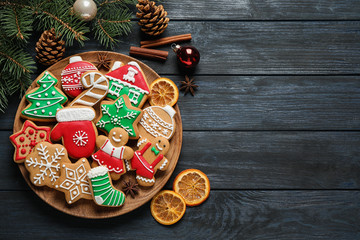 Flat lay composition with tasty homemade Christmas cookies on dark blue wooden table, space for text