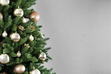 Beautiful Christmas tree with decor against light grey background. Space for text