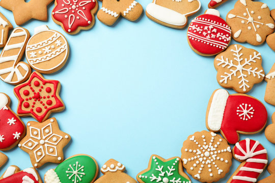 Flat lay composition with tasty homemade Christmas cookies on light blue background, space for text