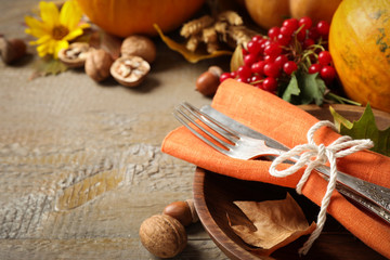 Fototapeta na wymiar Autumn vegetables and cutlery on wooden background, closeup with space for text. Happy Thanksgiving day