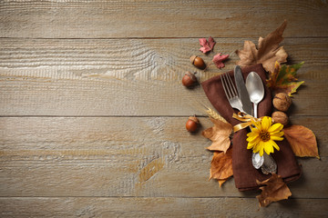 Cutlery and autumn decorations on wooden background, flat lay with space for text. Happy Thanksgiving day