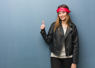 Young russian woman smiling and raising thumb up