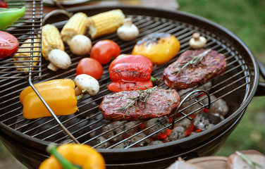Barbecue grill with tasty fresh food outdoors, closeup