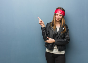 Young russian woman pointing to the side with finger