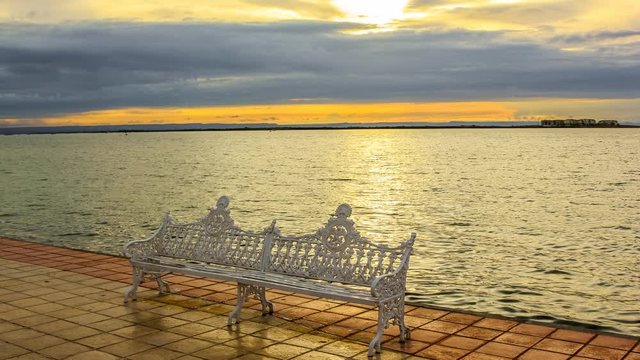 Iron bench on the waterfront of the La Paz, Mexico, Baja California Sur, at sunset. Cinemagraph loop background.