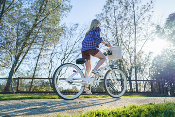 female on cruiser bike in park