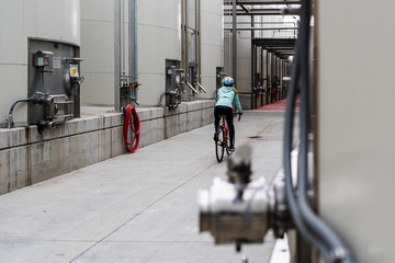 female on bike in industrial environment