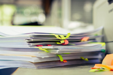 Stack of overwork of document report with post-it in business busy concept: Piles of paper files with postit on paperwork in overload at modern office - obrazy, fototapety, plakaty