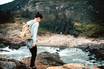 Young asian woman hiking at seaside mountain