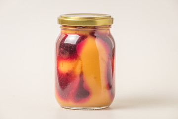 Latin American sweet caramel-like Manjar or Dulce de leche  with strawberry. Isolated on white background..