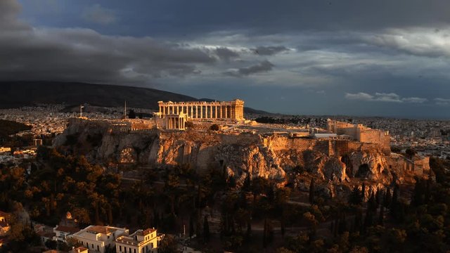 Aerial rising shot of the famous Parthenon temple and Acropolis at sunset. Athens, Greece