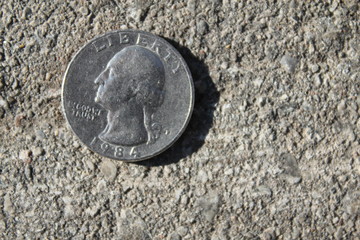 American 1984 Coin heads up on sidewalk