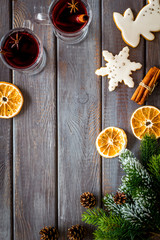 Mulled wine and fir branches frame on dark wooden background top view copy space