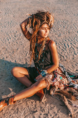 young hippie style woman on the beach at sunset