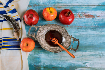 Shofar and tallit with glass honey and fresh ripe apples. Jewish new year symbols. Rosh hashanah